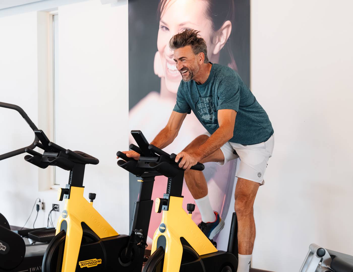 Fitness workout on one of the new Technogym machines in the modern gym of the wellness hotel