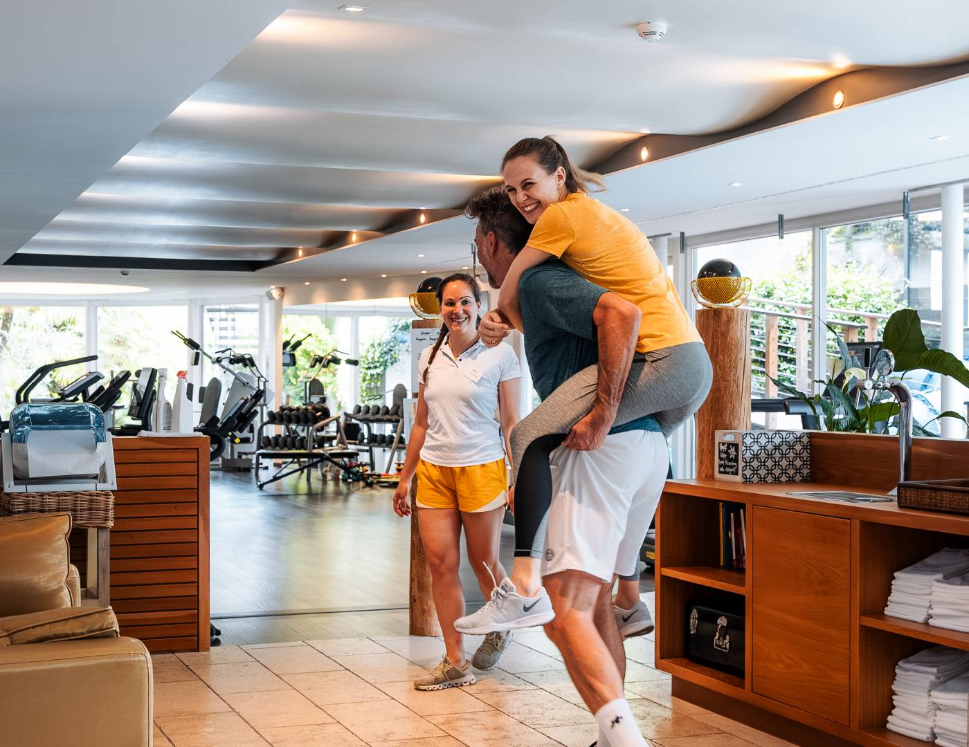 Smiling couple walking to the modern gym of the wellness hotel in Dorf Tirol, South Tyrol